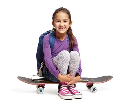 Girl sitting on her skateboard