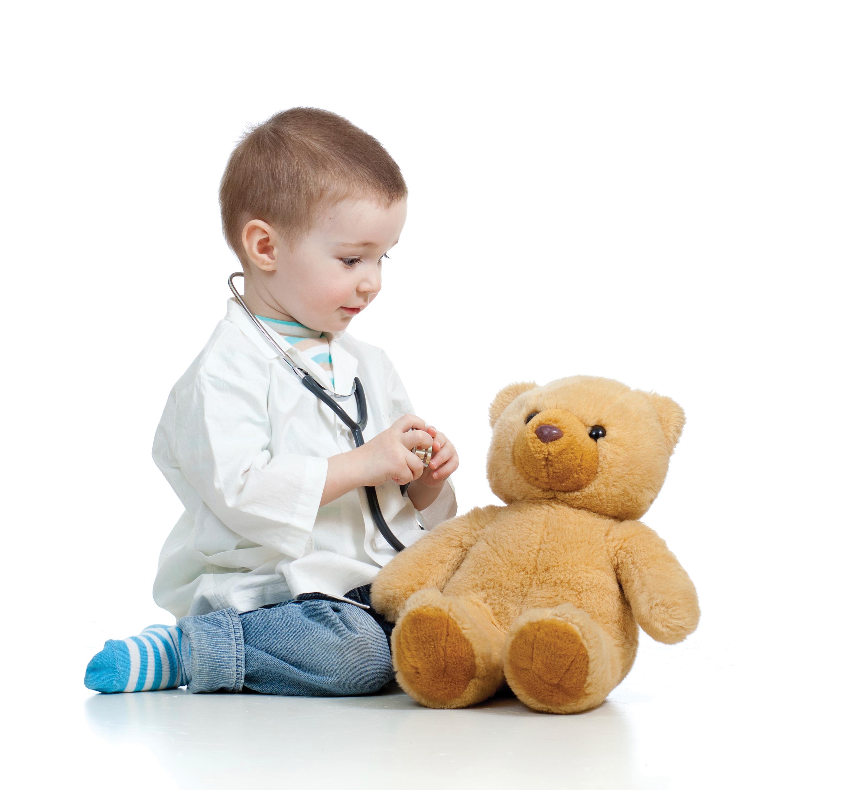 Little boy playing doctor with his bear