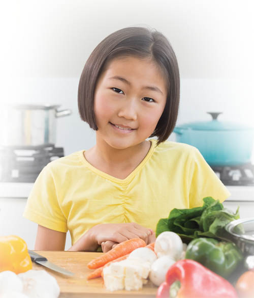 Smiling girl in front of healthy foods