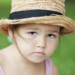 Girl wearing hat with frown on her face